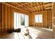 A bright living room with a sliding glass door and window, framed and awaiting finishing at 2650 Roswell Rd, Marietta, GA 30062
