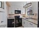 Well-lit kitchen featuring granite counters, white cabinets, and modern black appliances at 1687 Briarcliff Ne Rd # 8, Atlanta, GA 30306