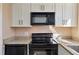 Close-up of the kitchen with black appliances and granite countertops at 1687 Briarcliff Ne Rd # 8, Atlanta, GA 30306