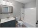 Clean bathroom with vanity, toilet, mirror, and shower-tub combo at 1800 E Lake Rd, Mcdonough, GA 30252