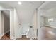 Hallway leading to bedroom with hardwood floors and staircase at 1800 E Lake Rd, Mcdonough, GA 30252