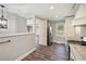 Modern kitchen showcases white cabinets, stainless steel appliances, and wood floors at 1800 E Lake Rd, Mcdonough, GA 30252