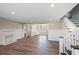 Bright open-concept living room features wood floors and a decorative fireplace at 1800 E Lake Rd, Mcdonough, GA 30252