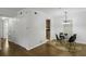 Bright dining area with wood floors, a modern chandelier, and a circular rug beneath the glass table at 2955 Seven Pines Se Ln # 203, Atlanta, GA 30339