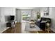 Bright living room with hardwood floors, stylish furniture, and a sliding glass door to a patio at 2955 Seven Pines Se Ln # 203, Atlanta, GA 30339