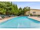 Inviting community pool area surrounded by lounge chairs and mature trees at 2955 Seven Pines Se Ln # 203, Atlanta, GA 30339