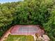 Aerial view of a fenced tennis court surrounded by lush greenery at 2955 Seven Pines Se Ln # 203, Atlanta, GA 30339