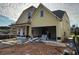 Two-story home with a two-car garage and covered porch, with some construction materials visible at 1243 Lakeside Overlook, Canton, GA 30114