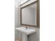 Elegant bathroom with a pedestal sink, framed mirror, and modern fixtures at 195 14Th Ne St # 2402, Atlanta, GA 30309
