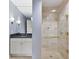 Modern bathroom featuring glass-enclosed shower with stone tile and vanity with granite countertop at 195 14Th Ne St # 2402, Atlanta, GA 30309