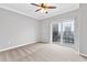 Cozy bedroom with carpet, a ceiling fan, and a sliding glass door to a balcony overlooking the city at 195 14Th Ne St # 2402, Atlanta, GA 30309