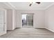 Bright bedroom with neutral carpet, ceiling fan, and sliding door to balcony with city view at 195 14Th Ne St # 2402, Atlanta, GA 30309