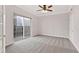 Cozy bedroom with neutral carpet, ceiling fan, and sliding door to balcony with city view at 195 14Th Ne St # 2402, Atlanta, GA 30309