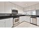 Modern kitchen with white cabinetry, stainless steel appliances, and black countertops at 195 14Th Ne St # 2402, Atlanta, GA 30309