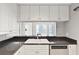 Updated kitchen featuring granite countertops, white cabinets, and stainless steel dishwasher at 195 14Th Ne St # 2402, Atlanta, GA 30309