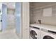 Convenient laundry area with front-load washer and dryer, plus shelving for storage at 195 14Th Ne St # 2402, Atlanta, GA 30309