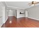 Open-concept living area with hardwood flooring, ceiling fan, and access to a kitchen at 195 14Th Ne St # 2402, Atlanta, GA 30309