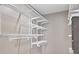 Organized walk-in closet with white wire shelving and hanging rods for maximum storage capacity at 195 14Th Ne St # 2402, Atlanta, GA 30309