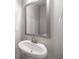 Bathroom features a pedestal sink with a decorative mirror and white fixtures at 2463 Quay Rdg, Lawrenceville, GA 30044
