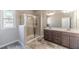 Bright bathroom featuring a glass-enclosed shower and double sink vanity at 2463 Quay Rdg, Lawrenceville, GA 30044