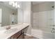 Bright bathroom features a shower and tub combination and a dark wood vanity at 2463 Quay Rdg, Lawrenceville, GA 30044