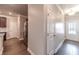 Hallway with stainless steel refrigerator, dark hardwood floors, and access to the front door at 2463 Quay Rdg, Lawrenceville, GA 30044