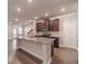 Modern kitchen features granite countertops, dark wood cabinets, and stainless steel appliances at 2463 Quay Rdg, Lawrenceville, GA 30044