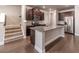 Stylish kitchen with granite counters, a large island, stainless steel appliances, and dark cabinetry at 2463 Quay Rdg, Lawrenceville, GA 30044