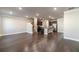 Spacious living room with hardwood floors, recessed lighting, and a view of the kitchen and staircase at 2463 Quay Rdg, Lawrenceville, GA 30044
