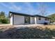 Modern home exterior with a concrete patio and sliding glass doors, offering seamless indoor-outdoor living at 54 Jean Ct, Hiram, GA 30141