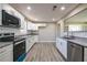Well-lit kitchen featuring white cabinets, stainless steel appliances, and granite countertops at 54 Jean Ct, Hiram, GA 30141