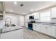 Stylish kitchen featuring gray-toned wood floors, modern appliances, and ample counter space at 54 Jean Ct, Hiram, GA 30141