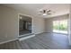 Spacious living room boasting wood floors, ceiling fan, and access to the outdoor space at 54 Jean Ct, Hiram, GA 30141