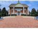 Elegant brick clubhouse featuring stately white columns, a classic facade, and a welcoming entrance at 281 Hiawassee Dr, Woodstock, GA 30188