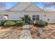 Attractive home featuring stone accents, a well-maintained lawn, and an inviting front entrance with potted plants at 281 Hiawassee Dr, Woodstock, GA 30188