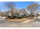 Beautiful home exterior boasts mature landscaping, a covered porch, and a well-maintained lawn on a sunny day at 281 Hiawassee Dr, Woodstock, GA 30188