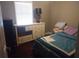 Bedroom featuring a white dresser and a comfortable bed with blue comforter and a bright window at 359 Cedar Ridge Trl, Lawrenceville, GA 30046