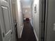 Hallway featuring white doors, hardwood floors, and neutral paint for a bright, cohesive design at 359 Cedar Ridge Trl, Lawrenceville, GA 30046