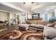 Basement area featuring a brown rug, a large sectional sofa, and a wood bar setup at 625 Sycamore Glen Nw Ct, Lawrenceville, GA 30044