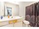 Standard bathroom with a toilet, sink, and shower/tub featuring a decorative shower curtain at 625 Sycamore Glen Nw Ct, Lawrenceville, GA 30044