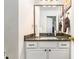 Half bathroom featuring granite countertop vanity with drawers, towel rack, and bronze hardware at 625 Sycamore Glen Nw Ct, Lawrenceville, GA 30044