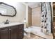 Cozy bathroom features a vanity, toilet, and tiled shower/tub combo with a patterned shower curtain at 625 Sycamore Glen Nw Ct, Lawrenceville, GA 30044