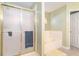 Bathroom featuring enclosed shower, soaking tub, tile floor and tile surround at 625 Sycamore Glen Nw Ct, Lawrenceville, GA 30044