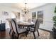 Elegant dining room features a stylish chandelier, large windows, and seating for six at 625 Sycamore Glen Nw Ct, Lawrenceville, GA 30044