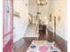 Inviting foyer with hardwood floors, a staircase to the upper level, and views into the living room at 625 Sycamore Glen Nw Ct, Lawrenceville, GA 30044