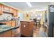 Eat-in kitchen with light wood cabinets, butcher block island, stainless appliances, and granite countertops at 625 Sycamore Glen Nw Ct, Lawrenceville, GA 30044