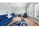 Bright living room with plush seating, fireplace, carpet and detailed shutters and trim at 625 Sycamore Glen Nw Ct, Lawrenceville, GA 30044