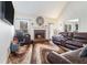 Cozy living room features a fireplace, comfortable seating, and large windows for natural light at 625 Sycamore Glen Nw Ct, Lawrenceville, GA 30044