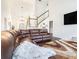 Comfortable living room features a large sectional, high ceilings, and a staircase to the upper level at 625 Sycamore Glen Nw Ct, Lawrenceville, GA 30044