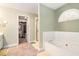 Bright bathroom with a large soaking tub, linen closet, and access to walk in closet at 625 Sycamore Glen Nw Ct, Lawrenceville, GA 30044